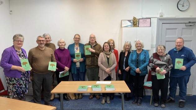 Photo of all participating poets and Janet Elmsley with their copies of the book